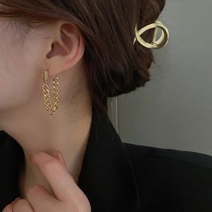 Close-up of elegant gold long chain drop earrings on a model with minimalist styling