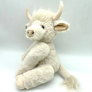 Detailed view of the soft white Highland Cow plush toy with fluffy long hair and curved horns