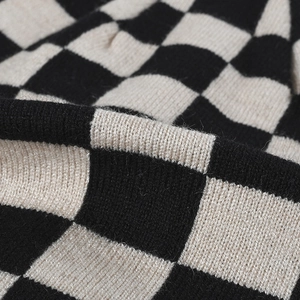 Classic black and white checkered knit beanie with thick warm texture for winter