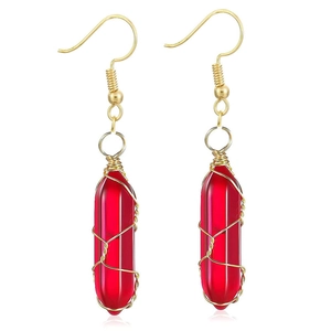 Detail of red hexagonal crystal earrings with golden wire wrap and fish hook clasp