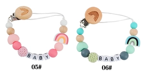 Detailed view of rainbow silicone pacifier clips with beech wood and crochet beads