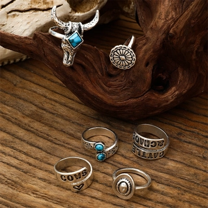 Bohemian silver ring set with turquoise and western motifs on textured driftwood