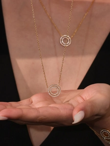 Close-up of 18k gold plated double ring necklace featuring sparkling 5A cubic zirconia stones