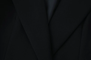 Close-up of the notch lapel and fine texture on this classic black tailored blazer jacket