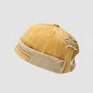 Detail of kids street style docker cap with distressed star patch and embroidery