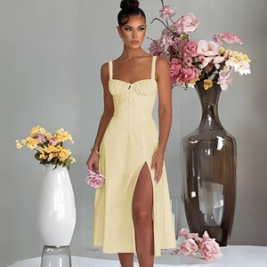 Detail of light yellow satin dress featuring corset bodice and high side slit design