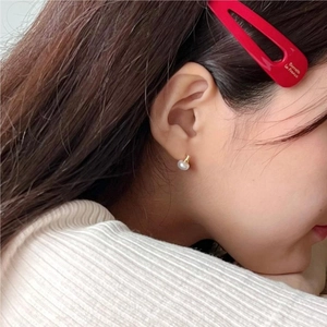 Minimalist 925 sterling silver freshwater pearl stud earrings worn by female model