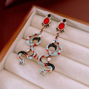 Vintage snake drop earrings with blue enamel, red gemstone, and sparkling rhinestones