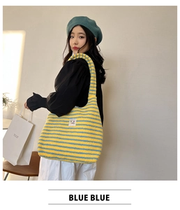 Detail of yellow and blue striped plush tote bag with large capacity and soft texture