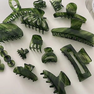 Detailed collection of elegant dark green acetate hair claws in various sizes and styles