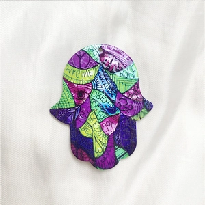 Detail of colorful Hamsa Hand acrylic pendants with inspirational English words and art
