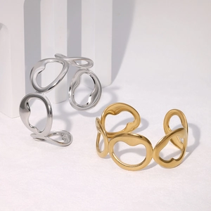 Minimalist stainless steel open bangle with irregular hollow circles in gold and silver