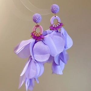 Detail of purple fabric flower tassel earrings with crystal beads and silver needles