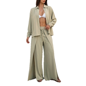 Women's two-piece set featuring light green pleated shirt and high slit wide leg trousers