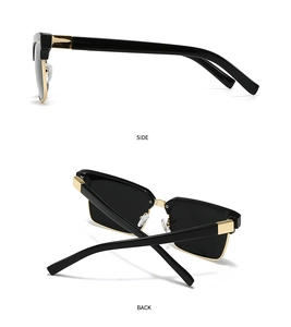 Detail view of black semi-rimless sunglasses with gold metal bridge and sleek temples