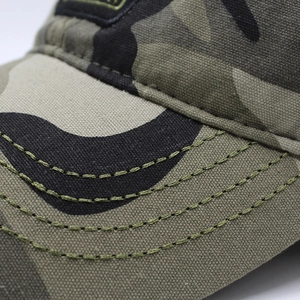 Macro shot of reinforced stitching on camouflage canvas brim of a baseball cap