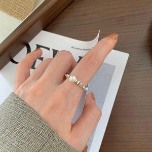 Detailed view of sterling silver textured ring with a round white pearl on hand