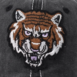 Washed dark gray baseball cap featuring detailed tiger head embroidery in vintage style