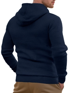 Detailed view of the dark blue waffle knit texture on a men's hooded sweatshirt back
