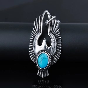 Detailed view of silver eagle pendant with blue turquoise inlay on black display