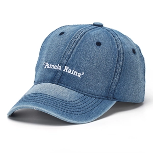 Detail of embroidered letters on light blue denim baseball cap with vintage wash finish