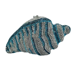 Detailed macro view of conch shaped luxury stone clutch bag with blue and silver crystals