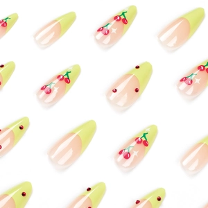French tip press-on nails with red cherry designs and rhinestones on long almond shape