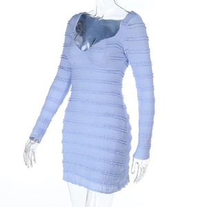 Side view of light blue mini dress featuring elegant ruched texture and fitted long sleeves