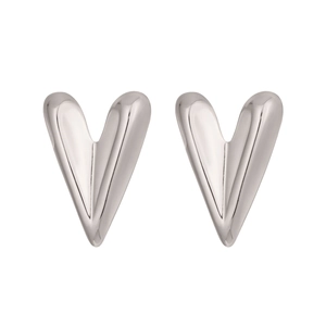 Detailed macro view of heart shaped silver stud earrings with polished mirror finish
