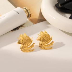Macro detail of gold-plated twisted wheat ear earrings with retro metallic texture
