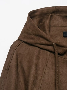 Close-up of brown faux suede hooded bomber jacket showing seam detail and fabric texture