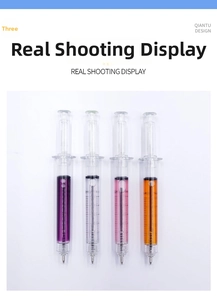 Detail view of four syringe-shaped pens with liquid filling and clear scale marks