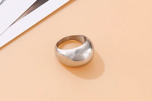 Close-up of polished silver stainless steel dome ring with mirror finish texture