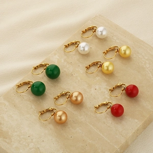 Détail de boucles d'oreilles en perles multicolores sur socle en pierre avec crochets