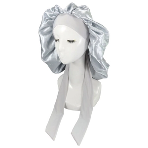 Detail of silver satin sleep bonnet with adjustable long ties on a model head