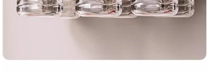 Close-up of organized glass containers stored on a retractable kitchen storage rack