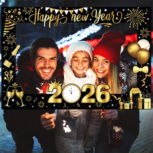 2026 Happy New Year photo booth frame in black and gold with festive party decorations