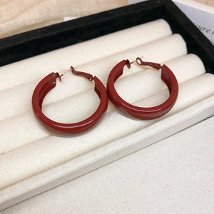 Retro burgundy C-shaped hoop earrings displayed in a white velvet jewelry box