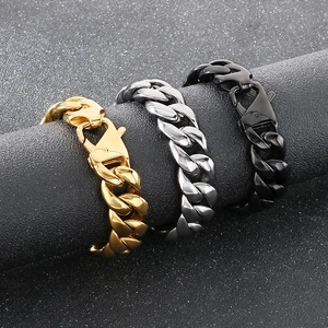 Detailed view of gold, silver, and black Cuban link bracelets with secure lobster clasp
