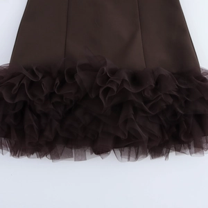 Detailed view of the dark chocolate brown mesh layers and fabric stitching on the dress