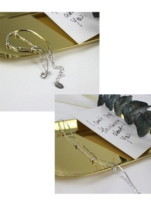 Macro shot of S925 sterling silver double-layer snake chain with polished beads