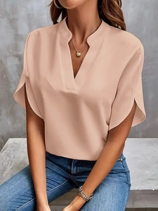 Detail of light pink V-neck chiffon blouse with elegant short raglan sleeves on a model
