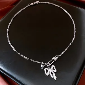Elegant silver-tone zircon bow pendant necklace with safety pin clasp on black leather