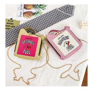 Detailed overhead view of gasoline can shaped chain bags with glitter finish and gold hardware