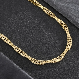 Macro detail of golden wheat fox chain necklace with double-woven steel links texture