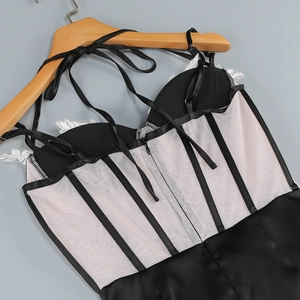 Detail of slim fit bodycon dress showing lace floral trim and corset style boning