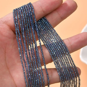 Close-up of 2mm faceted crystal glass beads in blue-purple with rainbow luster for DIY jewelry