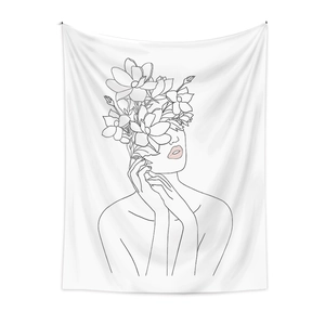 Detail of minimalist line art tapestry featuring woman with floral head decor