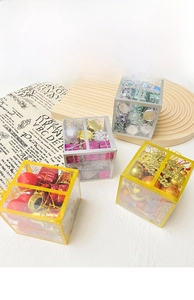 Close-up of 4-pack Christmas ball sets with 26 ornaments including drums and festive tags