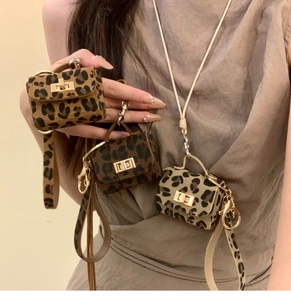 Detail of mini leopard print leather bag necklace with golden clasp and long strap